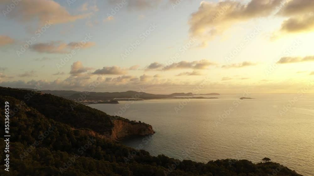 Aerial view of Cala Llonga beach, located in southern Ibiza, Spain. Beautiful aerial view of the bay at sunset Aerial view of Cala Llonga beach, located in southern Ibiza, Spain. Beautiful aerial view of the bay at sunset