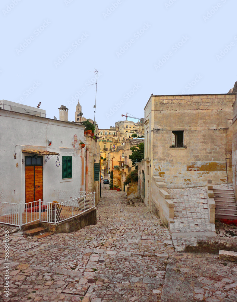 old narrow medieval street and picturesque stone houses in historical city of Matera, Basilicata Italy     