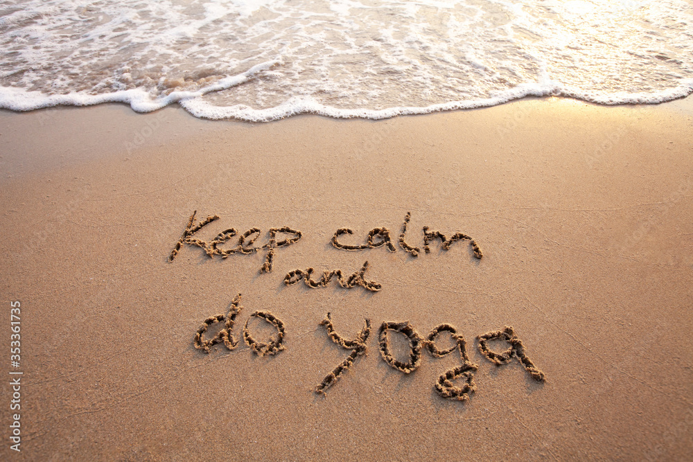 Fototapeta premium keep calm and do yoga, text on sand