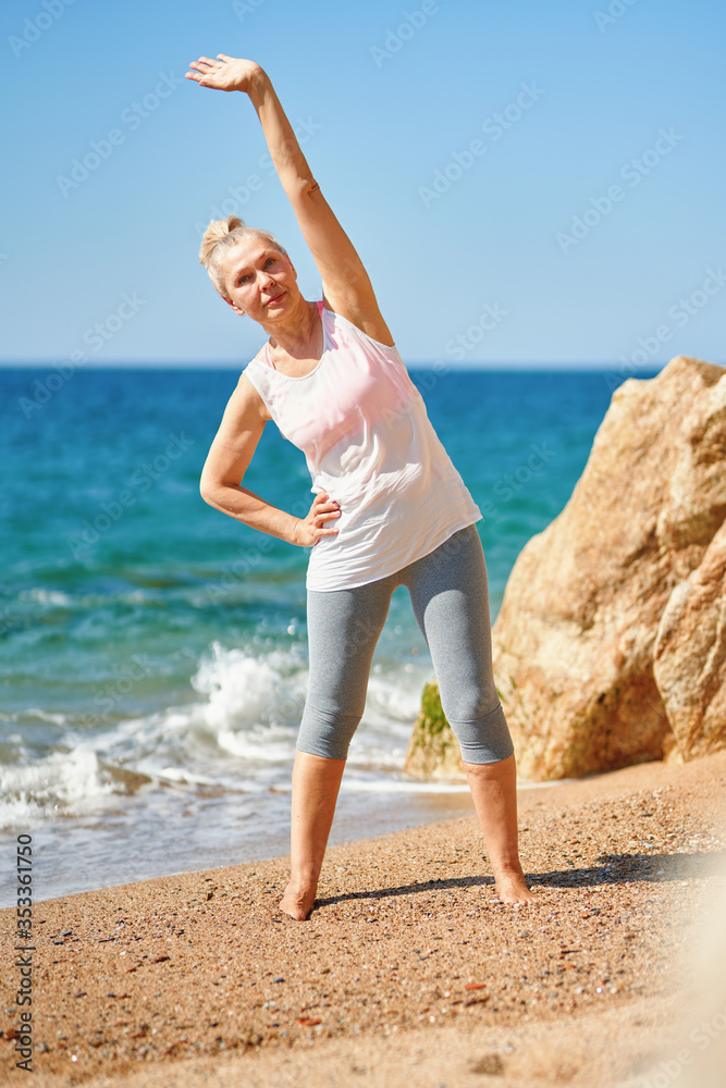 Adult attractive woman during sports by the sea Adult attractive woman during sports by the sea