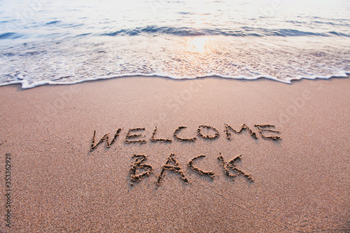 welcome back, text on sand beach, tourism after pandemic concept