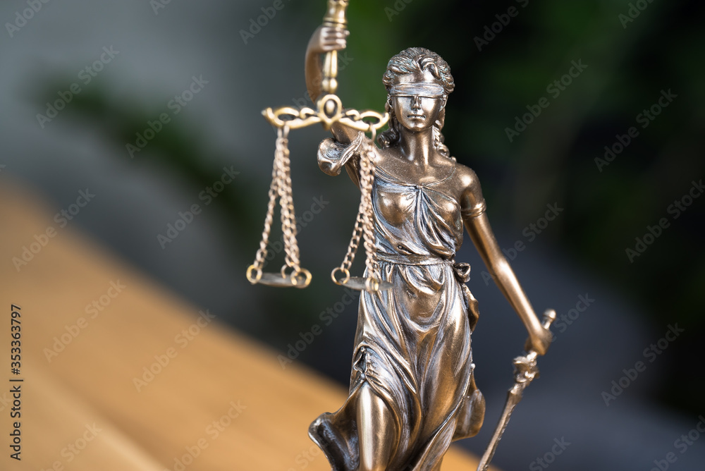 Law and Justice concept. Gavel of the judge, books, scales of justice. Gray stone background.