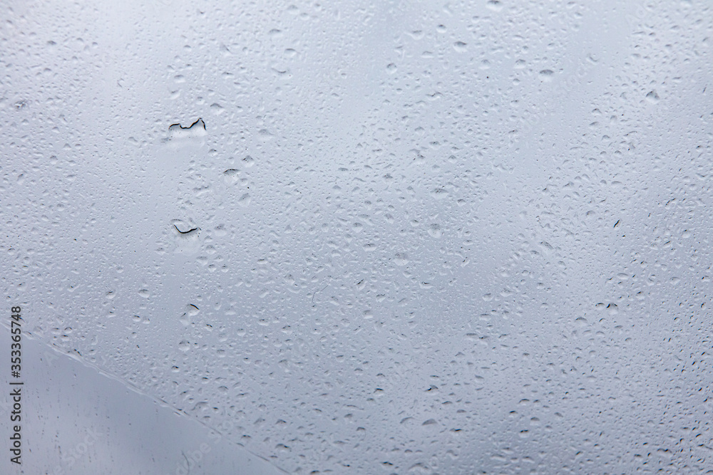 Wet drops of water on the glass. Close up photo of rain Wet drops of water on the glass. Close up photo of rain