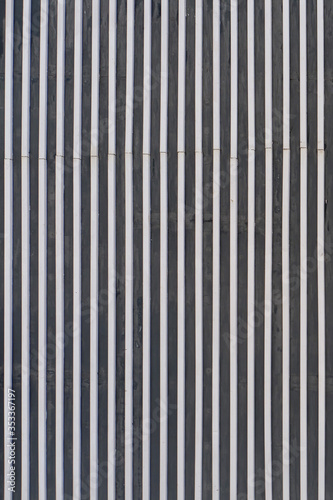 Wall background of vertical metal lines in industrial style