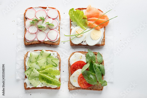 sandwiches with mascarpone cheese, cucumber, radish, eggs, caprese salad, salmon on a white background.