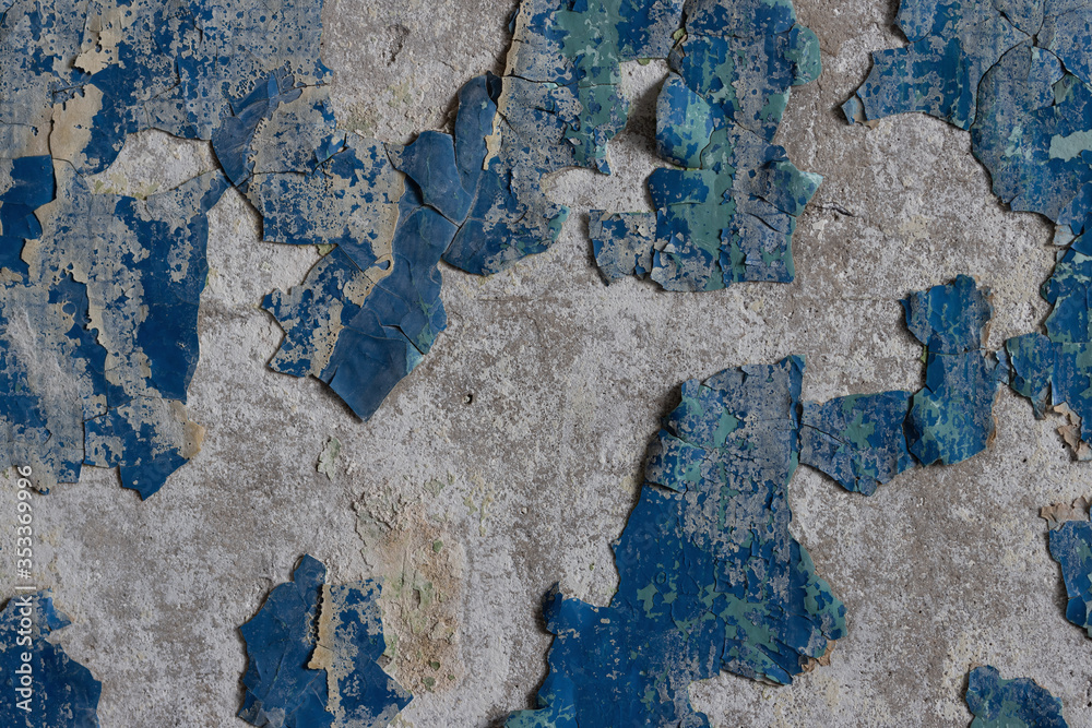 Blue peeling paint on the wall. Old concrete wall with cracked flaking paint. Weathered rough painted surface with patterns of cracks and peeling. High resolution texture for background and design. Blue peeling paint on the wall. Old concrete wall with cracked flaking paint. Weathered rough painted surface with patterns of cracks and peeling. High resolution texture for background and design.