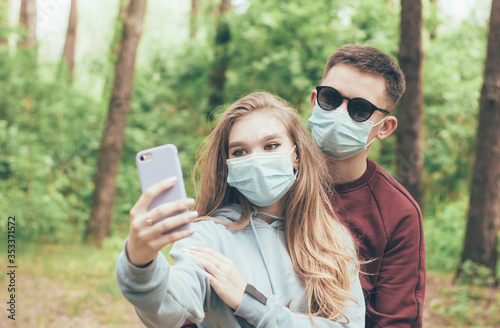 Medical masked couple taking selfie,Couple taking selfie in the forest