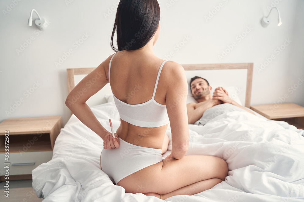 Happy spouse smiling at his wife in bed Happy spouse smiling at his wife in bed