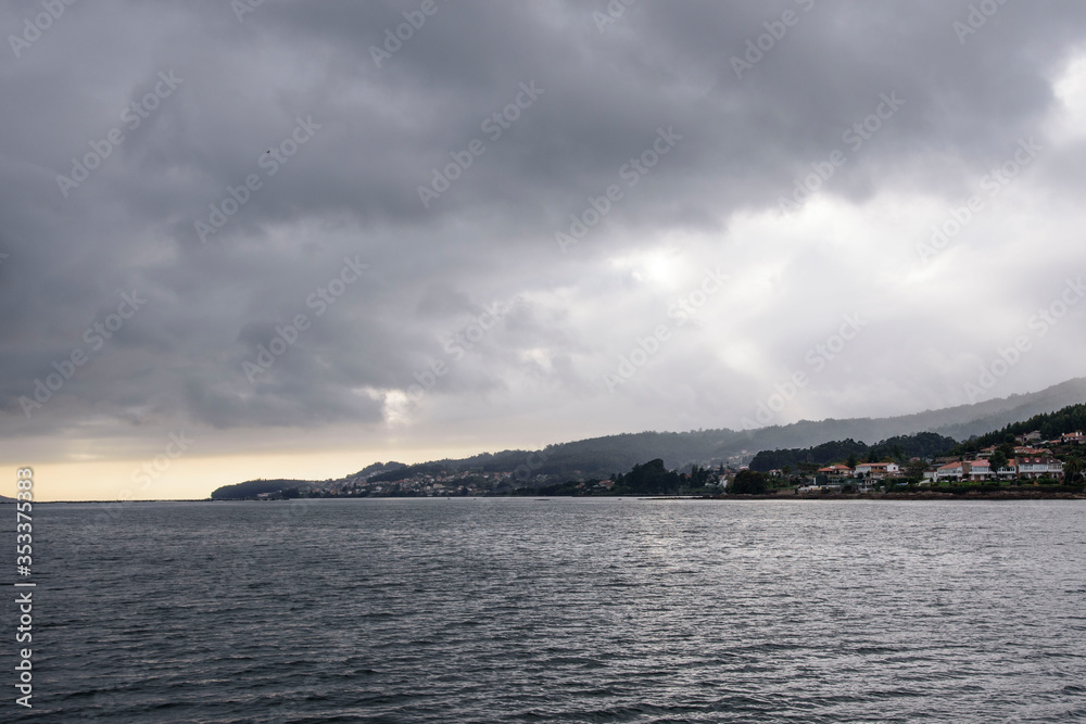 Views of evil land and sky, from a boat, of the Ria de Pontevedra in Galicia, Spain, Europe.