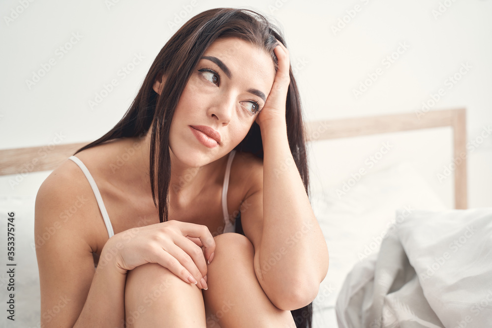 Dejected dark-haired Caucasian woman suffering from self-isolation Dejected dark-haired Caucasian woman suffering from self-isolation