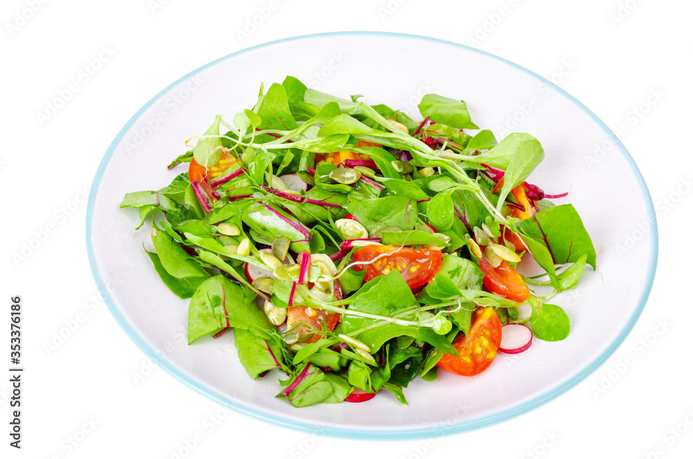 Salad of young leaves of beet, cherry, radish and pumpkin seeds.