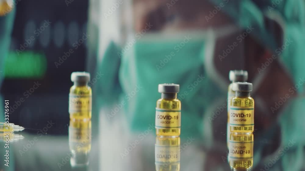 Doctor or Scientist Holding A Vaccine tube in the modern laboratory during the COVID-19 Corona virus pandemic period.