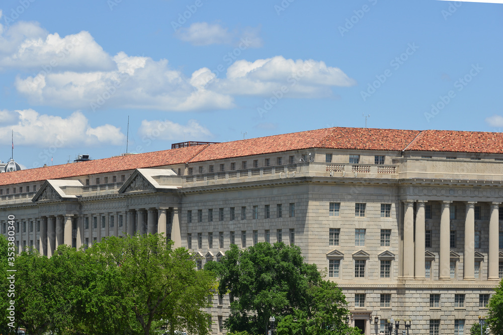 Washington DC, Department of Commerce Building with waving US flag