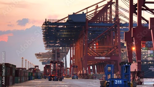 Container ship loading and unloading at night in the port of Hamburg / Germany