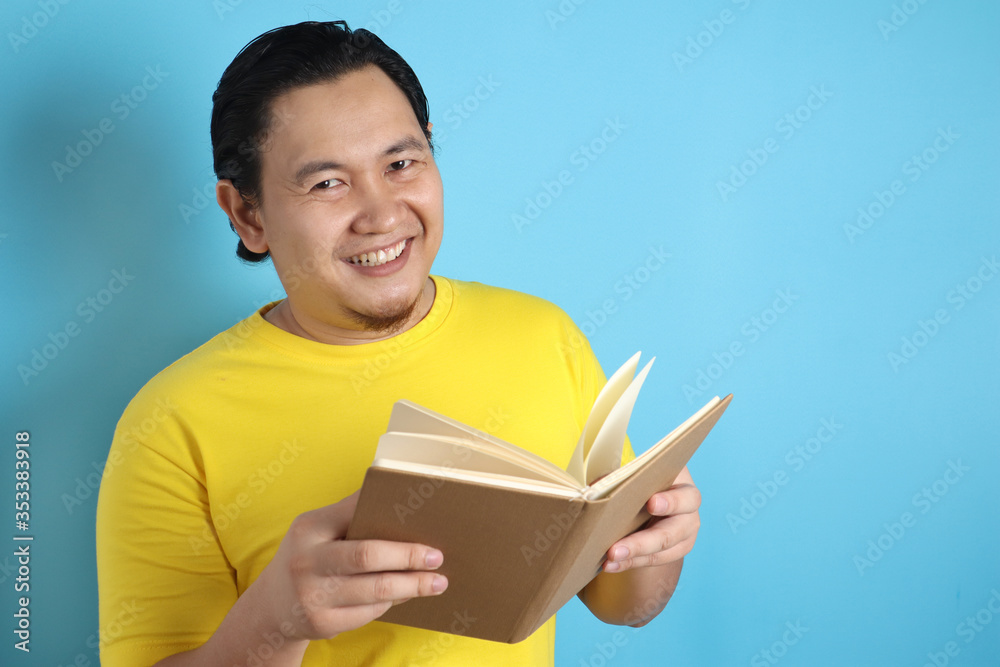 Happy Man Smiling While Reading Book Happy Man Smiling While Reading Book
