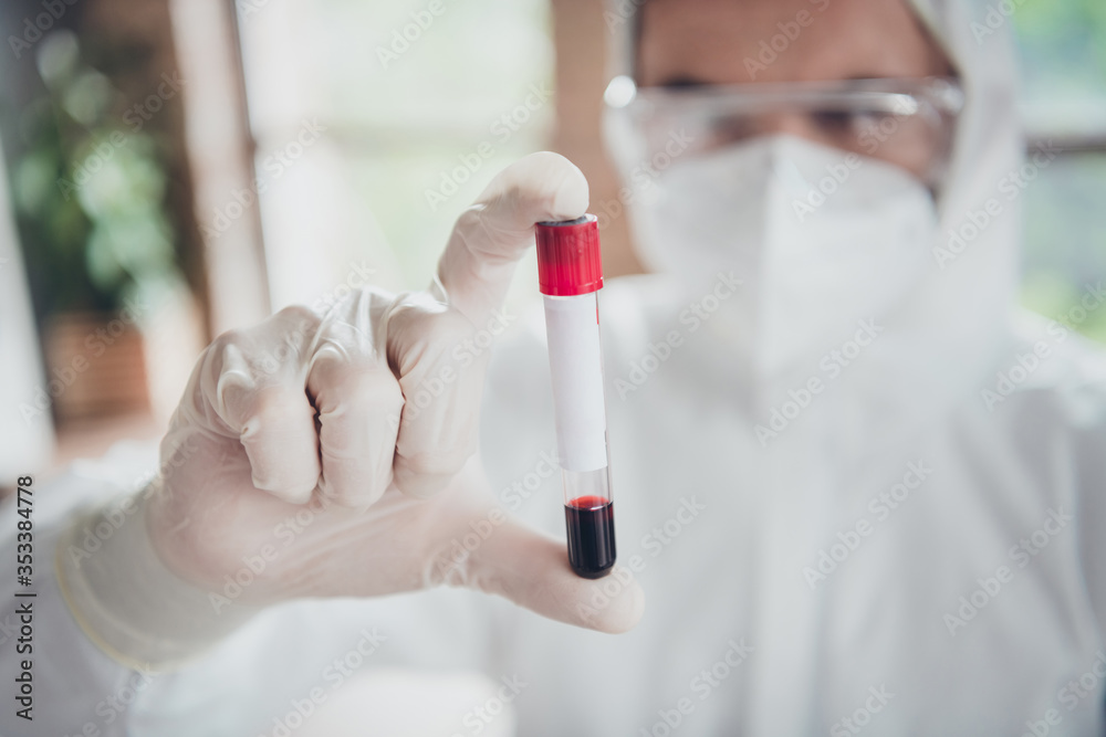 Closeup photo of corona virus blood probe sample medical test doc holding just collected tube examination covid flu cold patient wear face mask glasses gloves protective uniform indoors Closeup photo of corona virus blood probe sample medical test doc holding just collected tube examination covid flu cold patient wear face mask glasses gloves protective uniform indoors