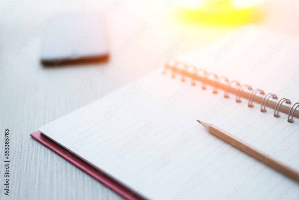 Top view of Notebook with pencil , and cup of coffee on white wooden table. Top view of Notebook with pencil , and cup of coffee on white wooden table.