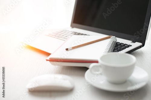 Laptop or Notebook Computers and pencil , notebook and cup of coffee on white