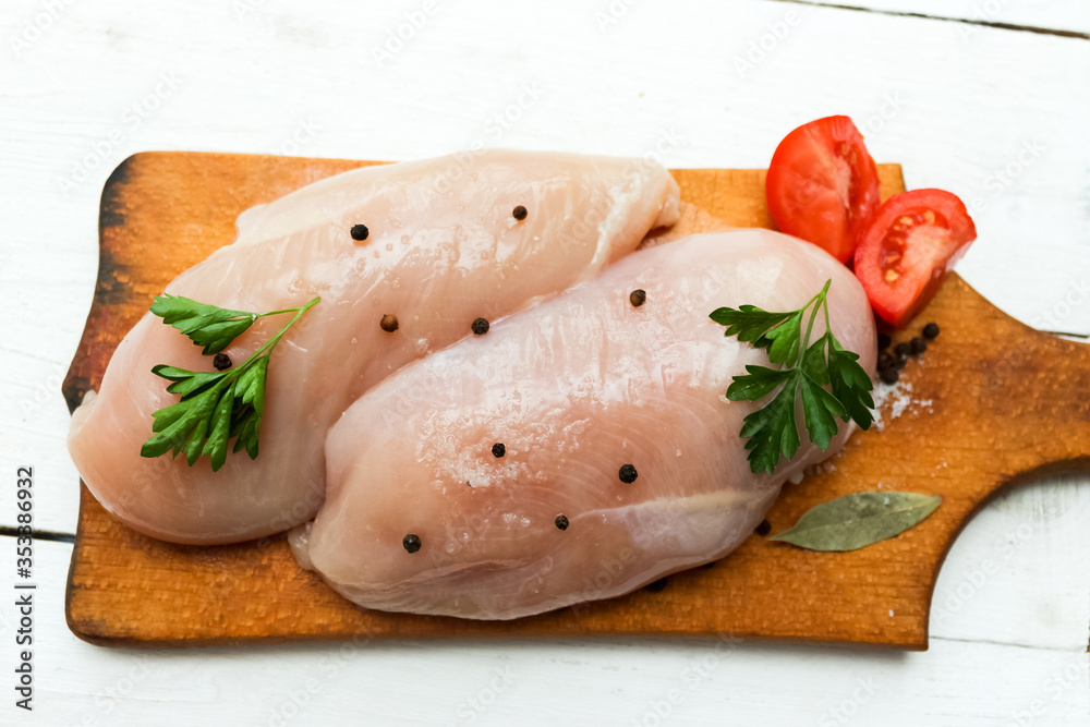 Raw chicken breast with tomato, parsley and spices
Raw chicken breast with tomato, parsley and spices