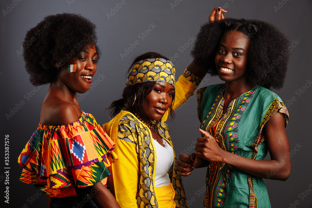 Three young beautiful African fashion models have fun and laughing in traditional  dress. Women from the Congo Republic, Ivory Coast, and Zimbabwe Stock Photo  | Adobe Stock