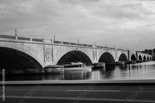 Memorial Bridge and a pleasure boat in motion blur riding in Potomac River - Washington D.C. United States of America