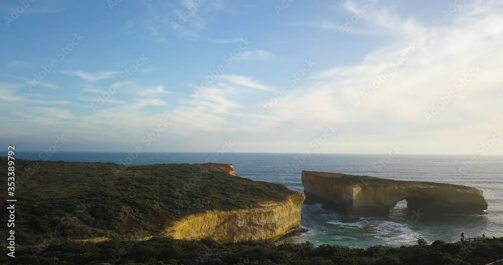 Aerial view of the London Arch at the Port Campbell National Park in Victoria, Australia at sunset with light coming from the ocean. Aerial view of the London Arch at the Port Campbell National Park in Victoria, Australia at sunset with light coming from the ocean.