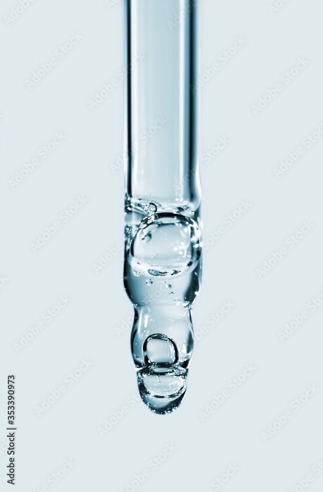 Cosmetic pipette with hyaluronic acid. Transparent gel with bubbles close-up. Gel cream or serum. A sample of a cosmetic product. Antibacterial gel. Cosmetic pipette with hyaluronic acid. Transparent gel with bubbles close-up. Gel cream or serum. A sample of a cosmetic product. Antibacterial gel.