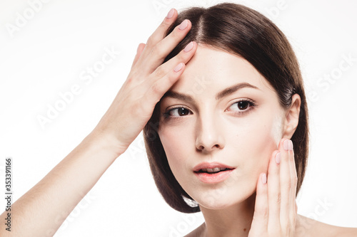 Young beautiful woman with hands portrait with healthy skin studio on white