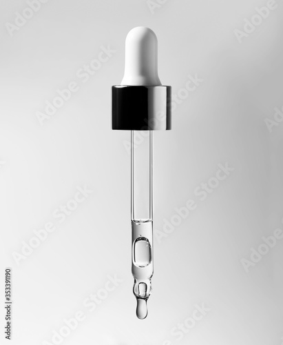 Cosmetic pipette with hyaluronic acid. Transparent gel with bubbles close-up. Gel cream or serum. A sample of a cosmetic product. Antibacterial gel.