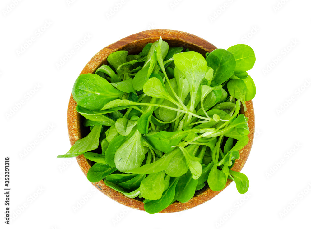 Wooden bowl with fresh green leaves of cornsalad Wooden bowl with fresh green leaves of cornsalad