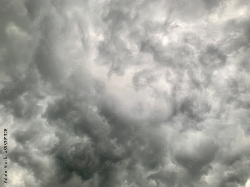 Obraz premium Black clouds formed before the rain, used for make a background image. Clouds become dark gray like a big smoke before rainfall. Thunderstorm is a storm with lightning and thunder.