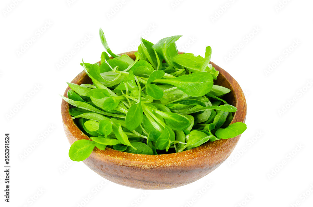 Wooden bowl with fresh green leaves of cornsalad Wooden bowl with fresh green leaves of cornsalad
