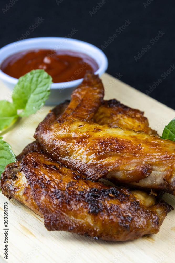 Baked chicken wings on wooden table