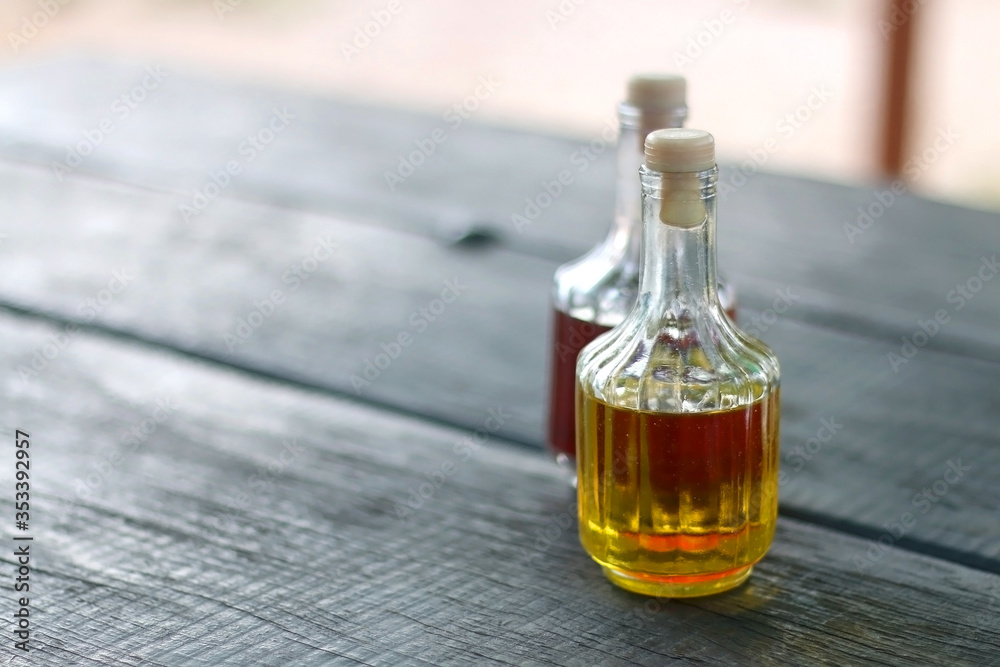 Bottles of olive oil and vinegar on a table. Selective focus. Bottles of olive oil and vinegar on a table. Selective focus.