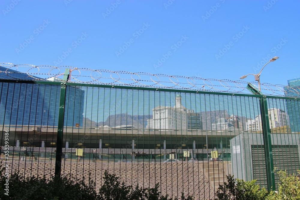 Downtown Cape town, Waterfront district, behind a high barbed fence. The Table mountain in the background. South Africa, Africa. Downtown Cape town, Waterfront district, behind a high barbed fence. The Table mountain in the background. South Africa, Africa.