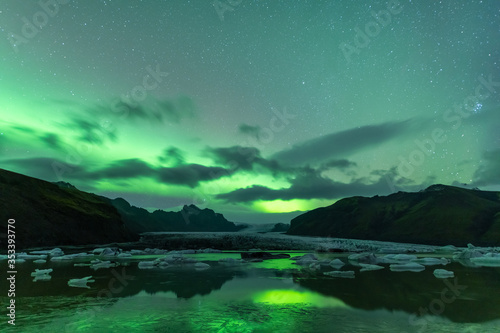 Aurora Borealis shining over beautiful lake in Iceland