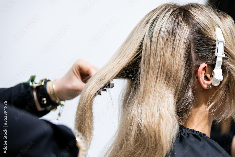 Fototapeta premium Professional hairdresser preparing client hair to haircut