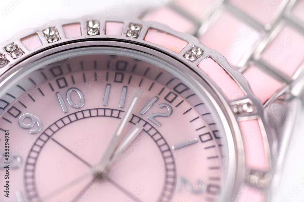 closeup pink wristwatch decorated with mother of pearl and artificial stone isolated on white background closeup pink wristwatch decorated with mother of pearl and artificial stone isolated on white background