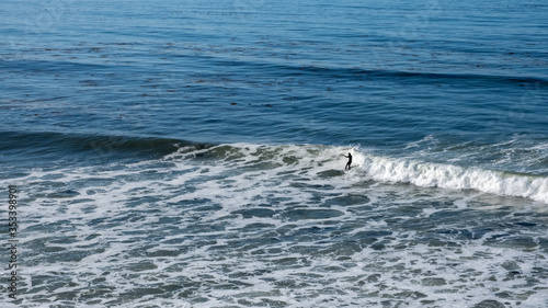 surfer in the sea and waves at San Luis Obispo, California © Gnac49