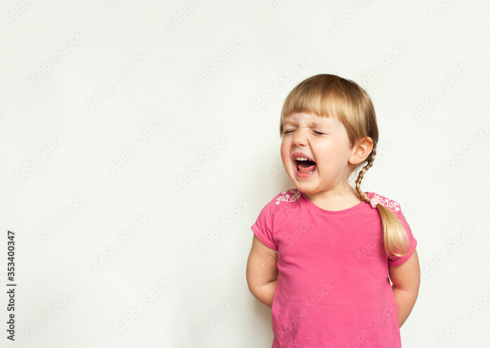 Cute blonde angry little girl screaming loudly on white background Cute blonde angry little girl screaming loudly on white background