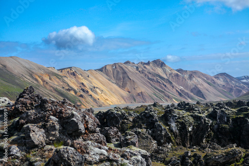 Landscape in Iceland. Green moss over the volcanic mountains and lava fields in Landmannalaugar national park. Beautiful colored mountains and lava fields.Surreal nature scenery in highland.