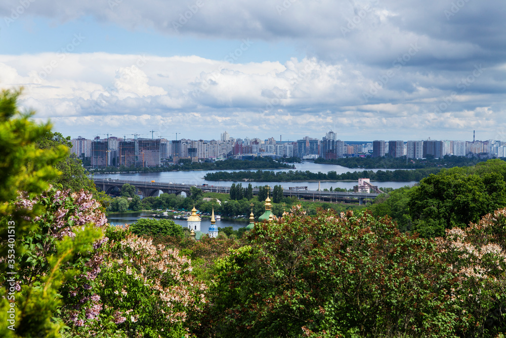 Cityscape of Kyiv with lilac blossom in spring.