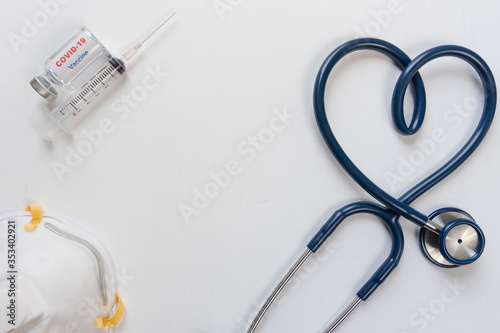 Covid-19 or coronavirus vaccine vial and syringe and Stethoscope with Heart symbol on white background.
