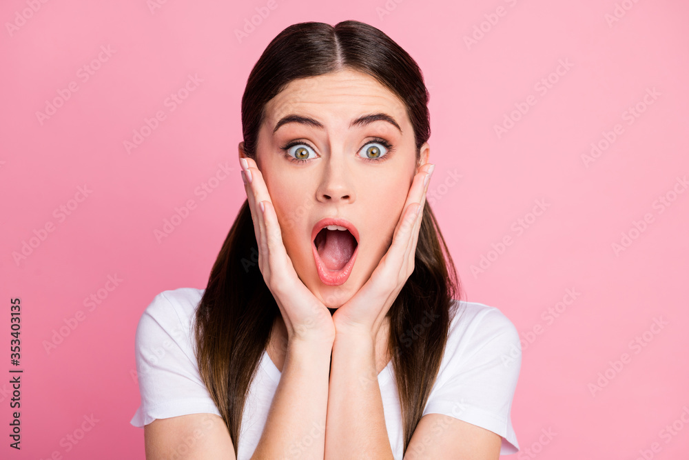 Closeup photo of pretty funny lady long hairdo tails open mouth listen amazing good news aspirations arms on cheeks wear casual white t-shirt isolated pastel pink color background