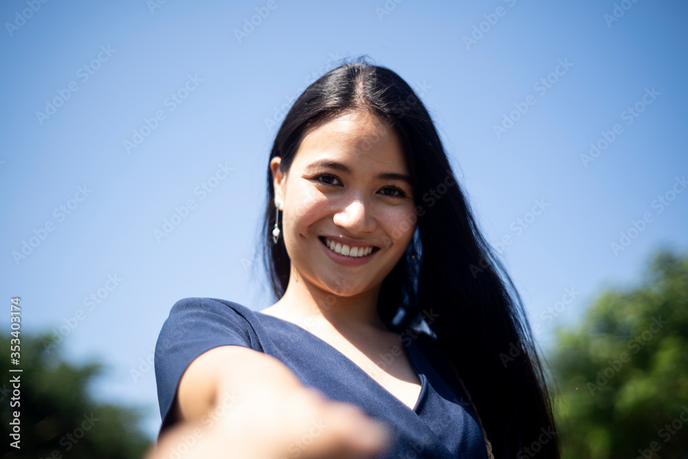Attractive woman under blue sky.