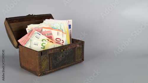 Money chest with lots of banknotes and copy space