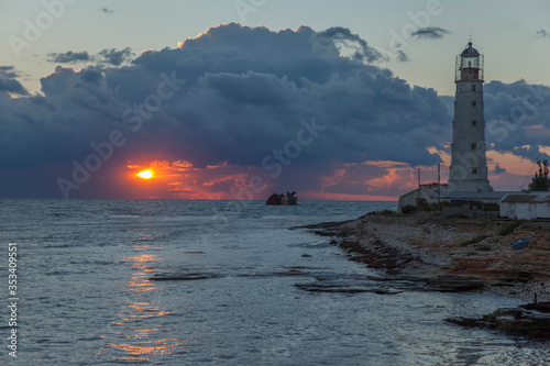 Lighthouse at Cape Tarkhankut at sunset. Crimea. Ukraine photo