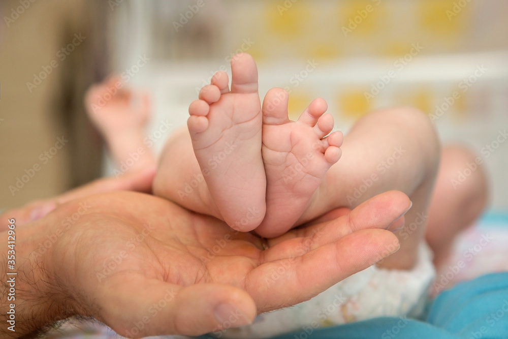 Baby feet in parent hands. Father and her child. Feet of newborn baby. Parenthood concept. Baby feet in parent hands. Father and her child. Feet of newborn baby. Parenthood concept.