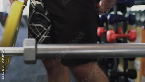 Unrecognizable man Disassembling barbell after exersice