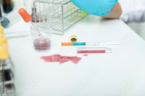 Researchers spilled infected blood or chemicals spilling over the table.